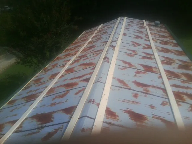 Rusted metal roof panels with new wood purlins before replacement — Storm Damage Roof Repair in Cove by Roofing Brothers