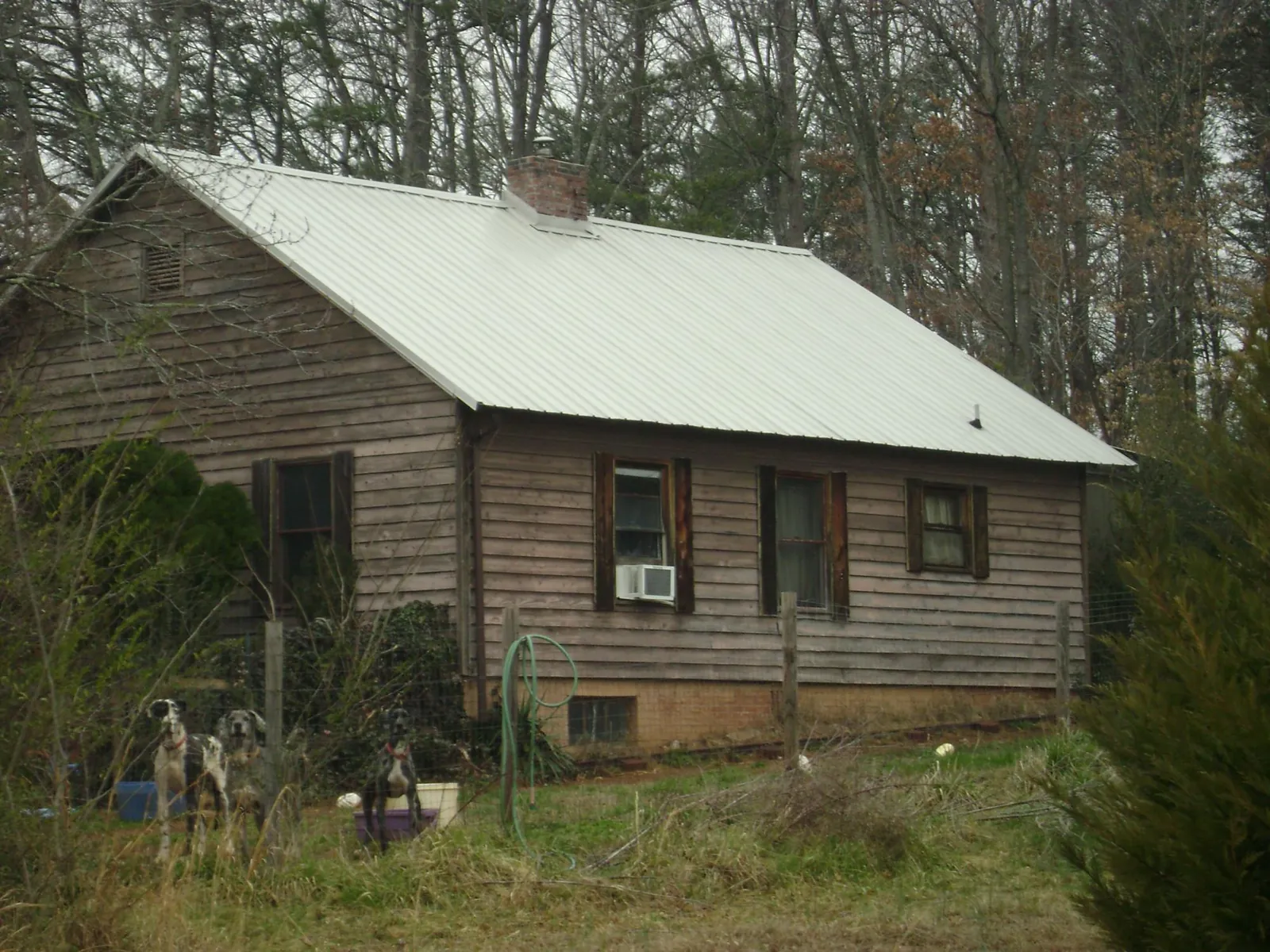White metal roof on an old wood sided farmhouse, from a Metal Roof Installation job in Cove
